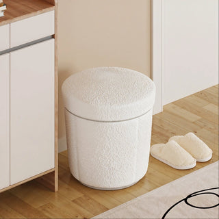 Boucle storage ottoman placed beside a bathroom vanity for cozy seating and hidden storage.