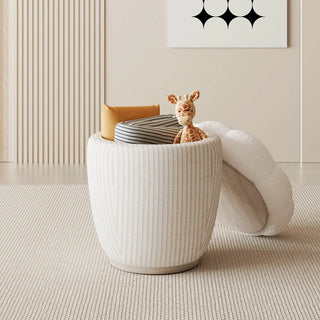 Open view of the boucle ottoman with lid lifted to reveal spacious hidden storage for books or toys.