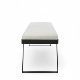 End view of white boucle bench highlighting the contrast between ivory upholstery and black metal frame