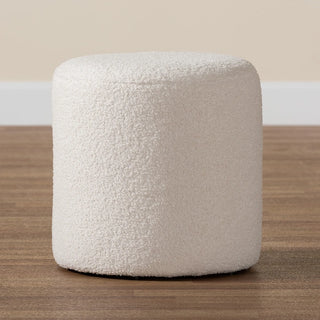Close-up of ivory boucle ottoman on wood surface"