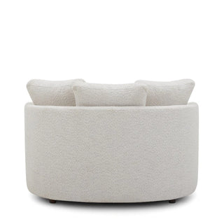 Back view of cream oversized boucle chair with rounded silhouette
