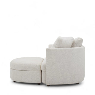 Side angle of cream oversized boucle chair showing curved design