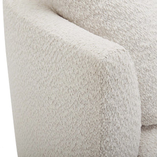 Close-up texture of cream boucle fabric on oversized chair