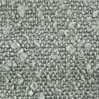 Close-up of sage tweed fabric showing textured weave with light and dark speckles.