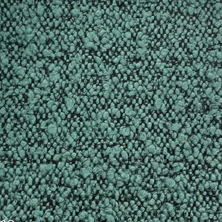 Close-up of teal tweed fabric featuring woven pattern with multicolored specks.