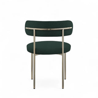 Rear view of green boucle dining chair showing metal frame construction