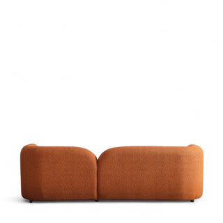 Rear view of orange boucle sofa displaying texture and form