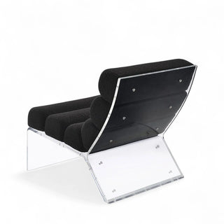 Rear view of black boucle accent chair showing back construction and frame