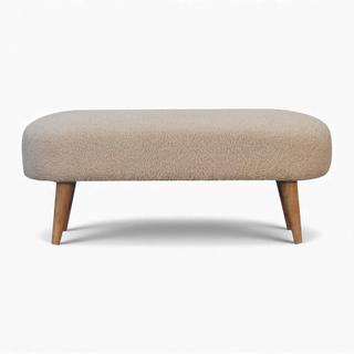 Front view of a modern beige bouclé upholstered bench with rounded edges and angled wooden legs.
