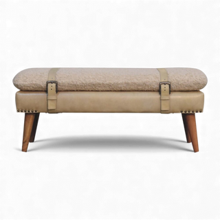 Beige upholstered bench with wooden legs on a white background