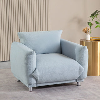 Light blue boucle armchair in styled living room setting with neutral decor