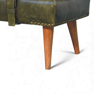 Close-up of a green leather chair with wooden legs on a white background