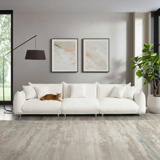 Boucle couch in a styled living room setting with matching throw pillows and neutral decor.