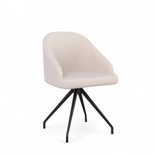 Angled view of the boucle desk chair featuring its compact form, white fabric, and dark metal base.