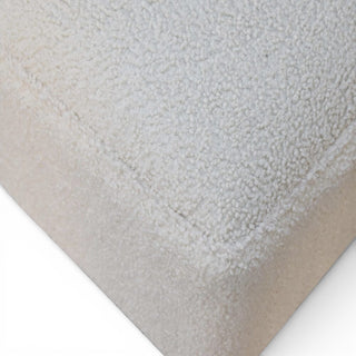 Close-up of a textured beige fabric on a white background