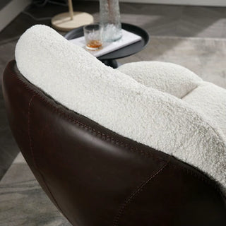 Close-up of the boucle lounge chair’s faux leather back and boucle seating material for contrast.