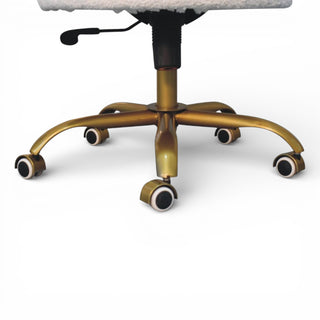 Close-up of a gold office chair base on a white background