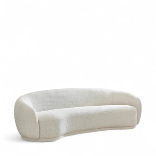 Beige curved boucle sofa with rounded silhouette and foam cushioning