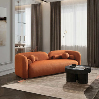 Orange boucle sofa in minimalist interior with natural lighting