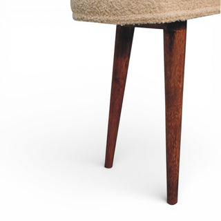 Close-up of a chair leg with a wooden finish on a white background