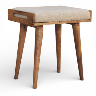 Wooden stool with a cushioned seat on a white background