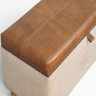 Brown leather and beige fabric ottoman on a white background