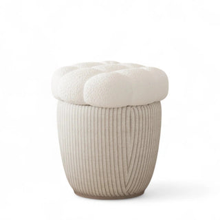 Front view of the beige boucle storage ottoman featuring a tufted cloud-style cushion and ribbed fabric base.
