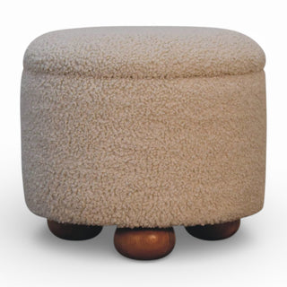 Round beige ottoman with wooden legs on a white background