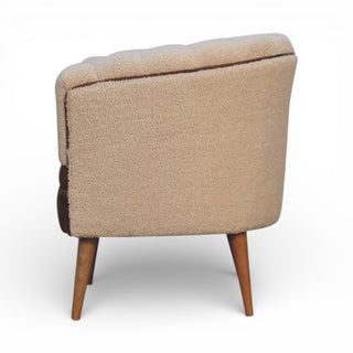 Beige armchair with wooden legs on a white background