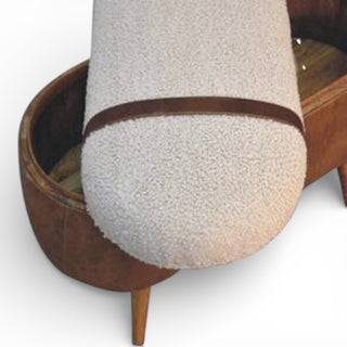Wooden ottoman with a textured cushion on a white background