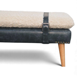 Sofa with a leather strap and wooden leg on a white background