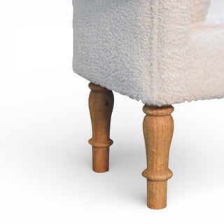 Close-up of a textured chair with wooden legs on a white background