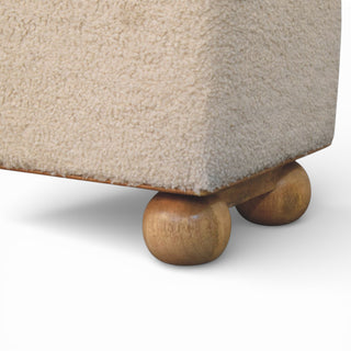 Close-up of a textured surface with wooden legs on a white background