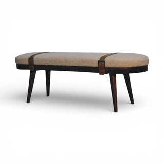 Beige ottoman with brown leather straps on a white background