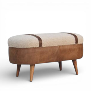 Oval-shaped ottoman with brown leather and white cushion on a white background