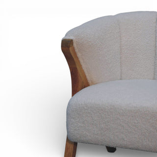 Gray upholstered chair with wooden armrest on a white background