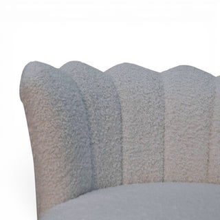 Textured pillow with scalloped edge on a white background