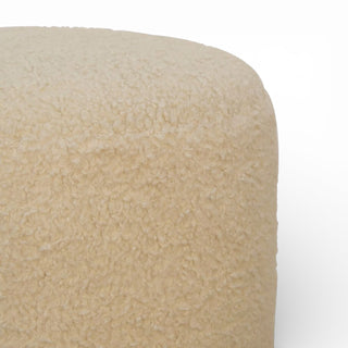 Close-up of a beige textured ottoman on a white background