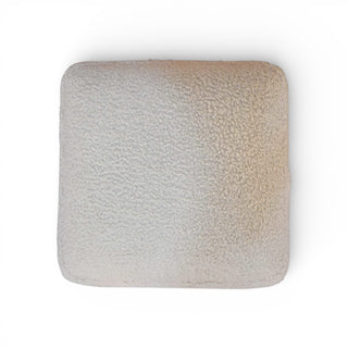 Square textured cushion on a white background