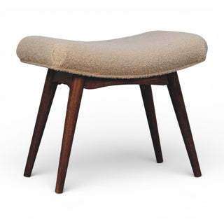 Beige cushioned stool with wooden legs on a white background