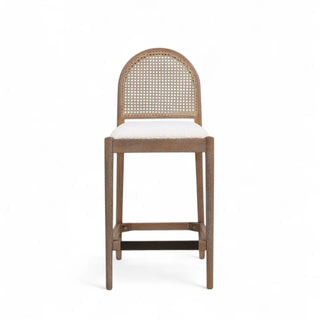 Front view of counter stool with natural cane back panel, solid oak frame, and ivory boucle upholstered seat