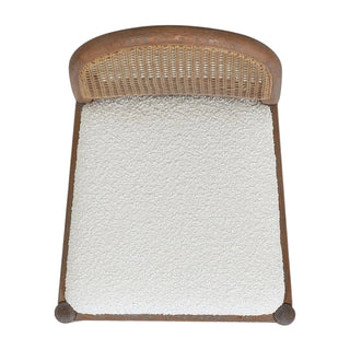 Overhead view of counter stool showing ivory white boucle upholstered seat, natural cane webbing backrest, and medium brown oak wood frame construction