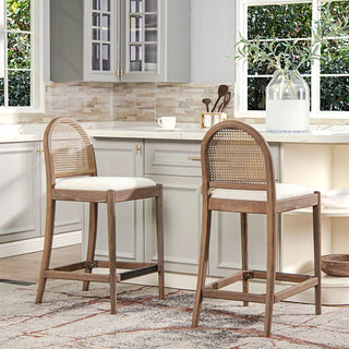 Set of two cane back counter stools positioned at kitchen island showing practical usage in home setting