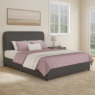 Charcoal gray boucle upholstered bed frame with rounded corners in contemporary bedroom with pink bedding