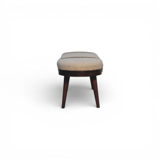 Small ottoman with a cushioned top on a white background