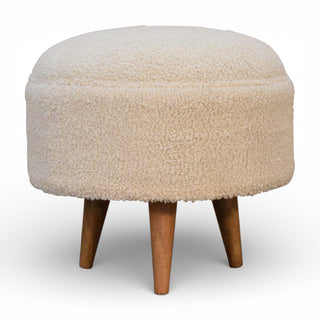 Round ottoman with a fluffy beige cushion and wooden legs on a white background