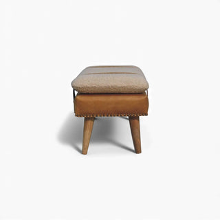 Stool with cushioned top and wooden legs on a white background