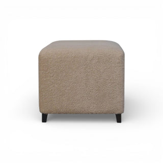Beige cube ottoman on a white background
