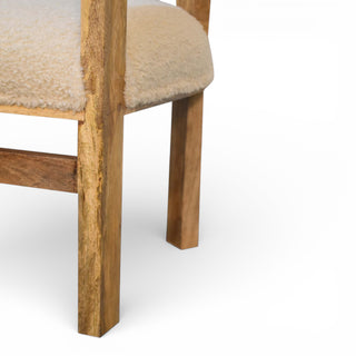 Close-up of a wooden chair with beige cushioned seat and backrest on a white background