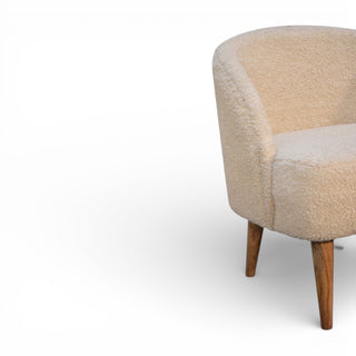 Beige armchair with wooden legs on a white background